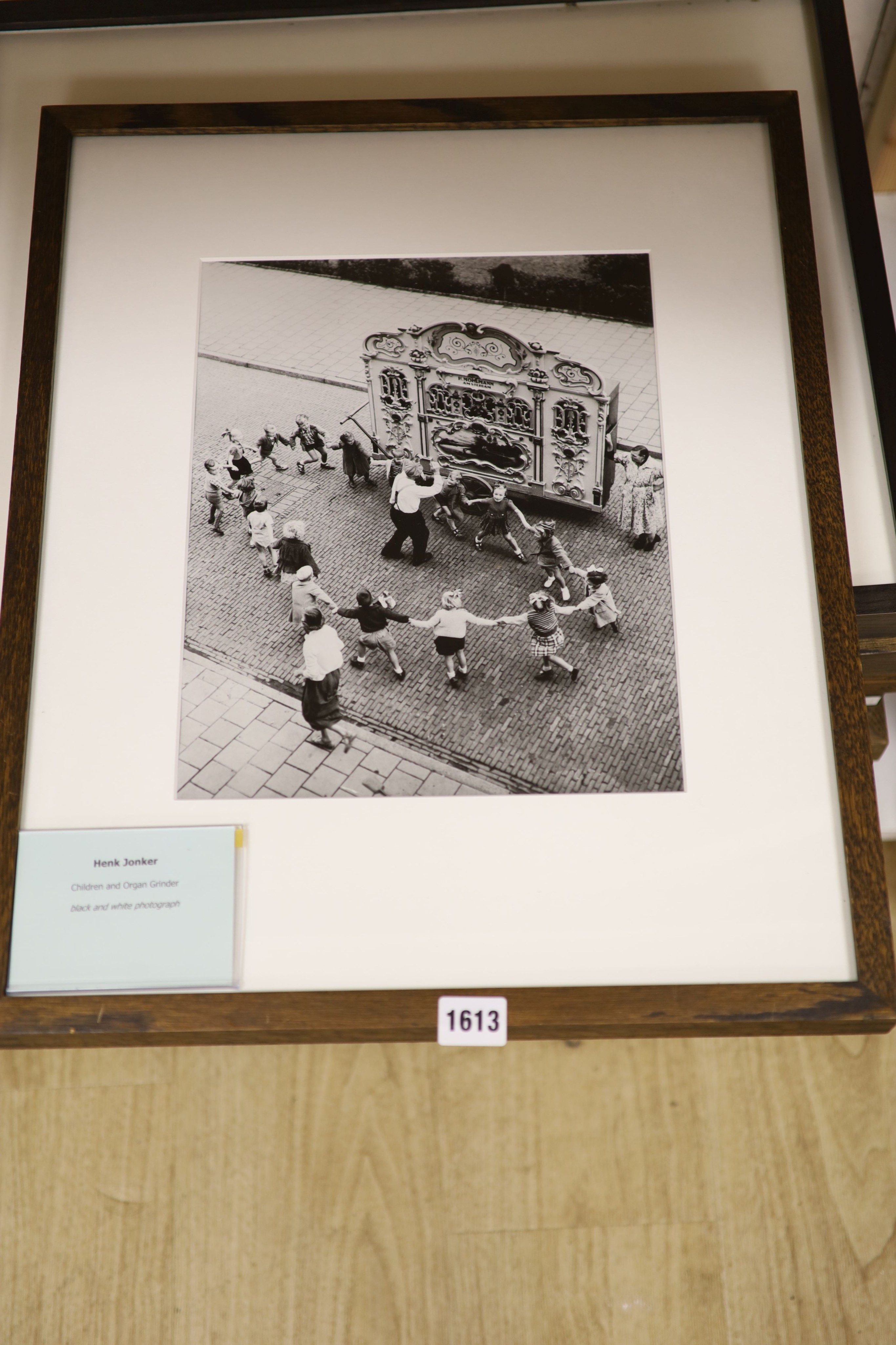 A collection of modern black and white photographs: Henk Jonker, Children and organ grinder, Roger Mayne, Please Mr Take My Photo, Unknown, The Village Hall, Christian Pizal